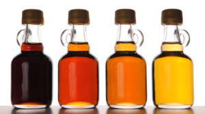 Different grades of maple syrup in bottles